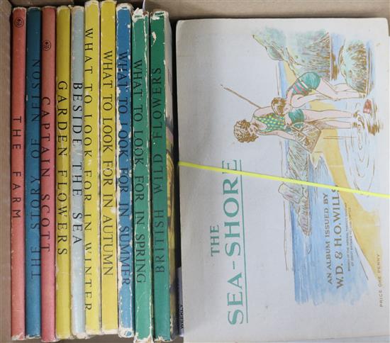 A collection of 16 Ladybird books and seven albums of tea and cigarette cards,